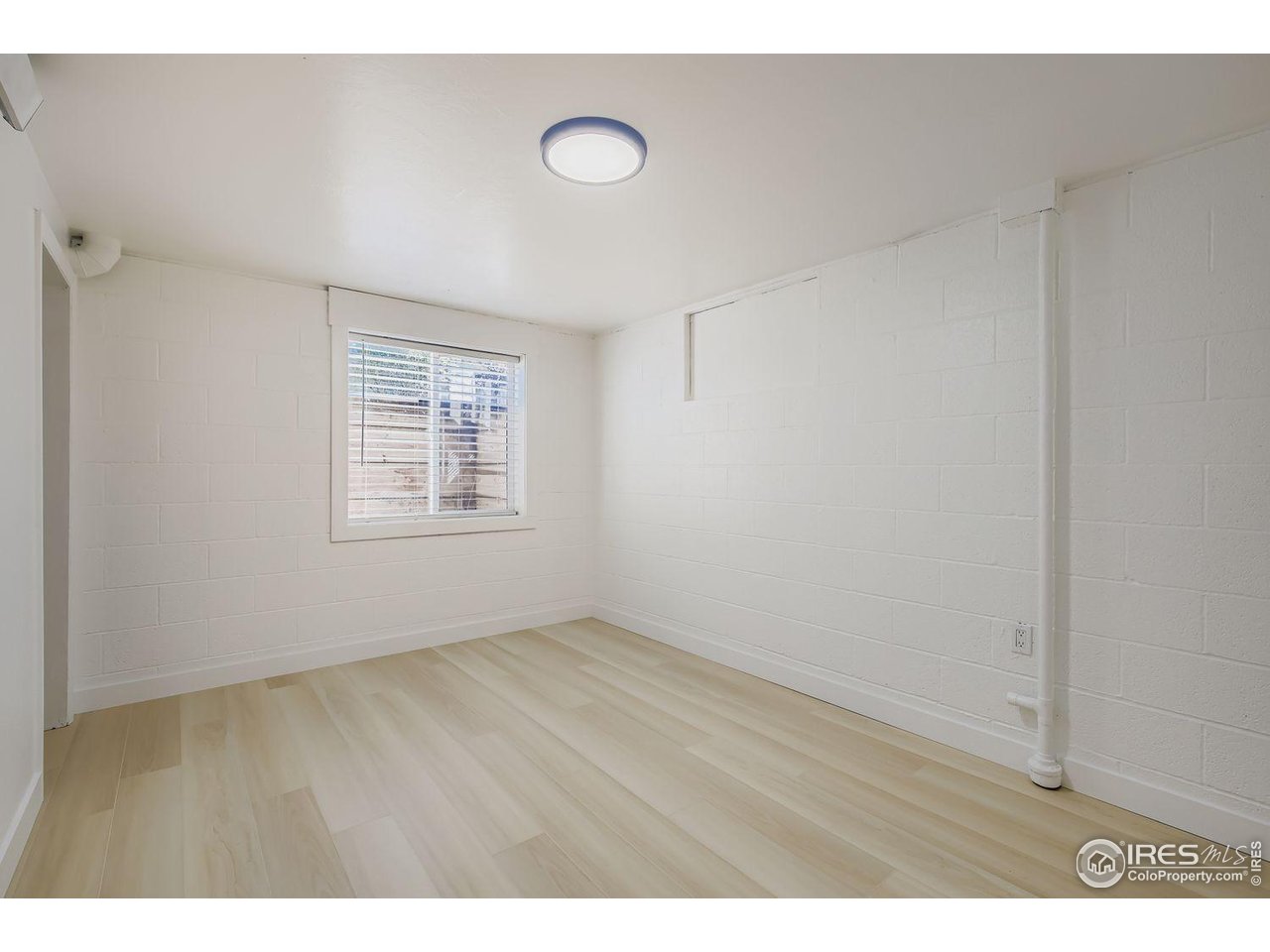 604 Colorado Street Fort Collins, CO 80524 - Photo 22 of 32 a view of an empty room with wooden floor and a window