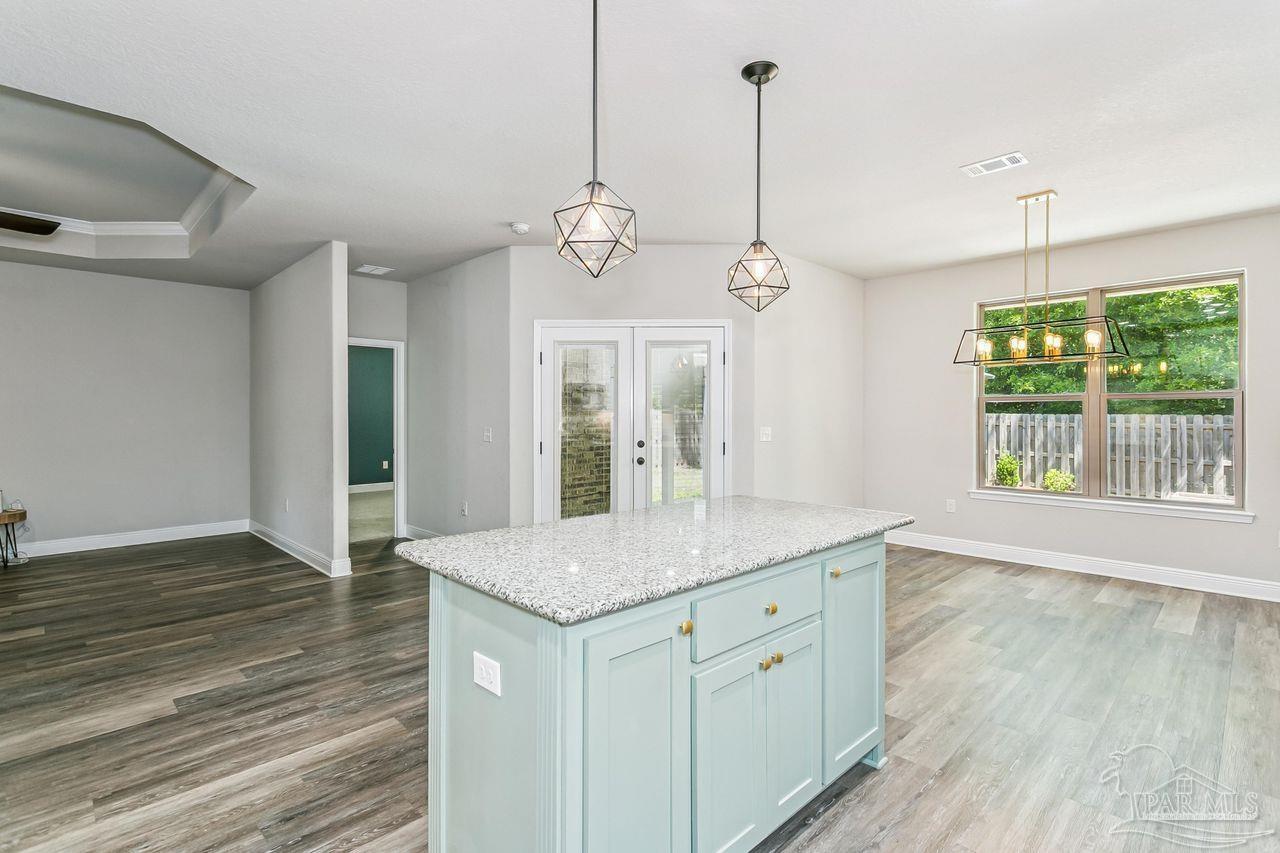 3875 Shady Grove Drive Pace, FL 32571 - Photo 12 of 31 a view of a kitchen counter space wooden floor and staircase