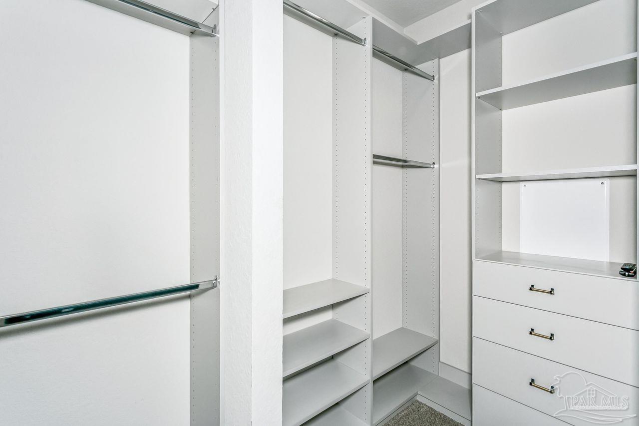 3875 Shady Grove Drive Pace, FL 32571 - Photo 17 of 31 a view of walk in closet with empty racks