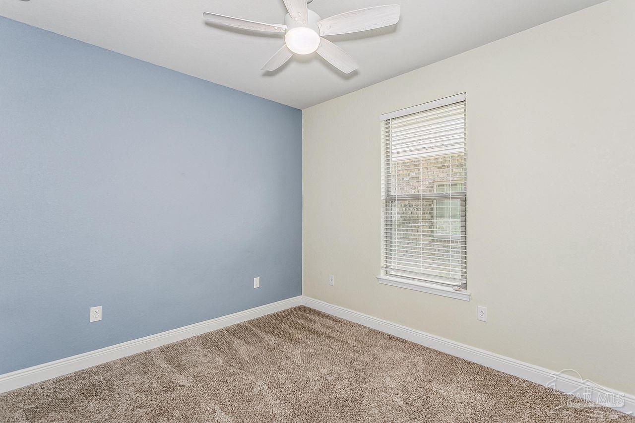 3875 Shady Grove Drive Pace, FL 32571 - Photo 21 of 31 an empty room with windows and fan