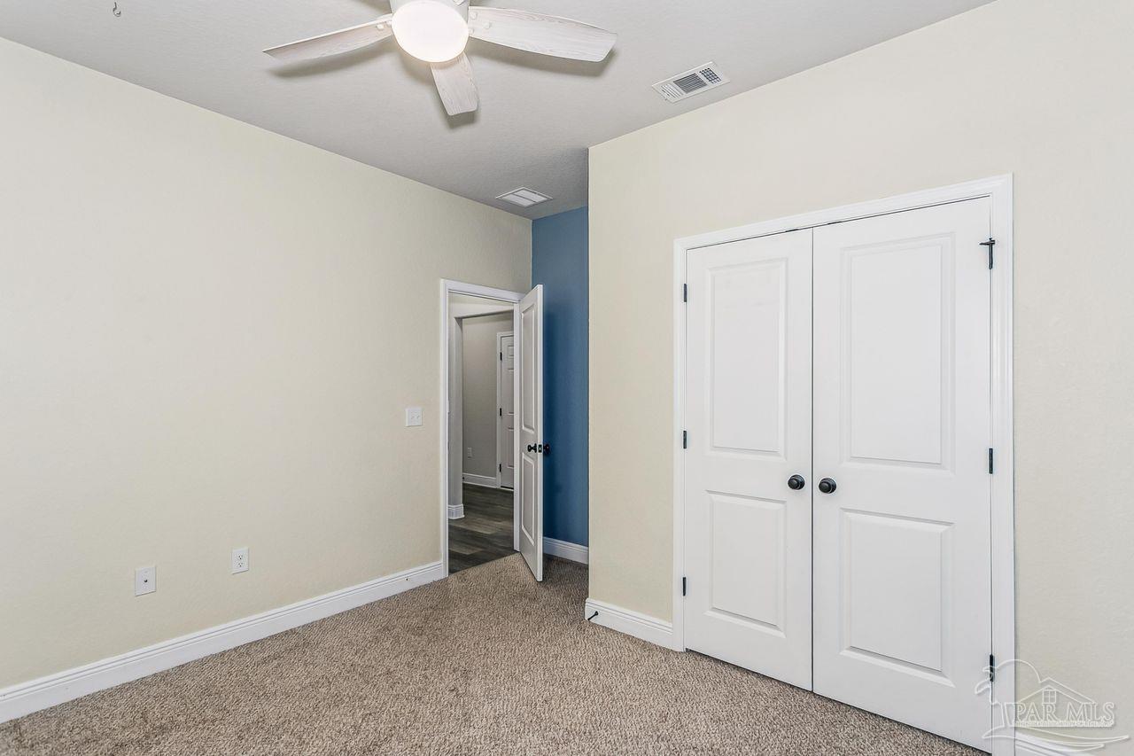 3875 Shady Grove Drive Pace, FL 32571 - Photo 22 of 31 wooden floor in an empty room