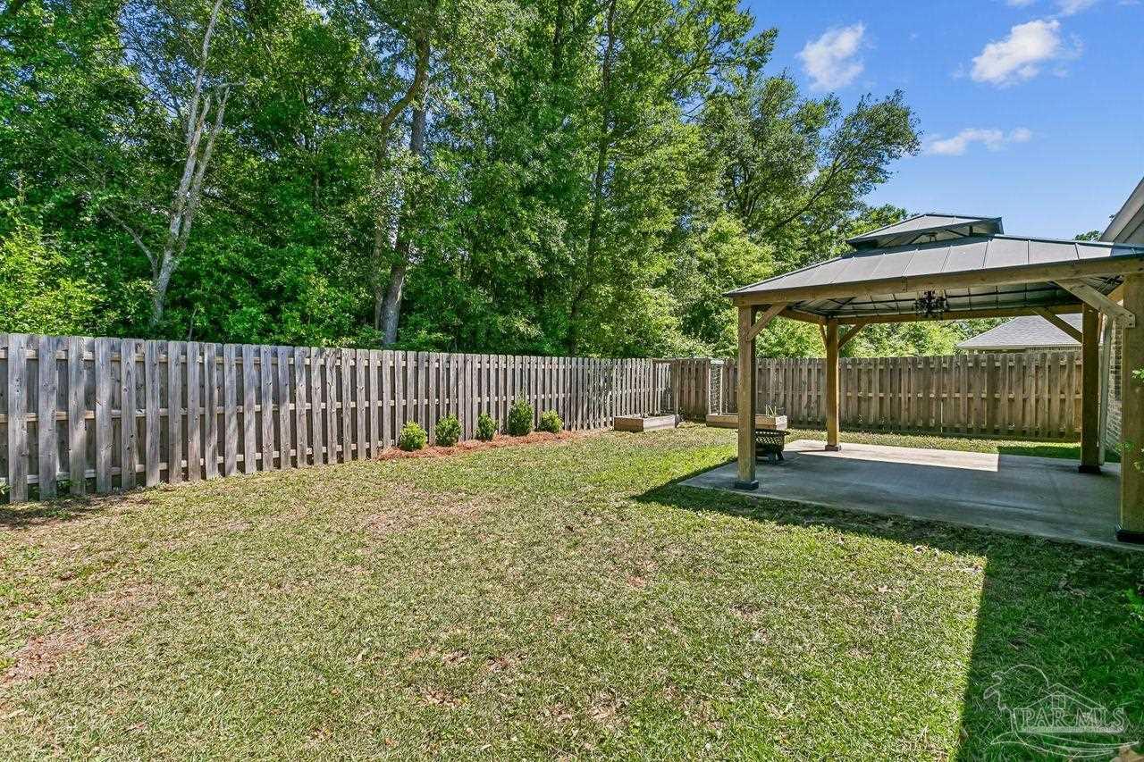 3875 Shady Grove Drive Pace, FL 32571 - Photo 28 of 31 a view of a backyard with a swing