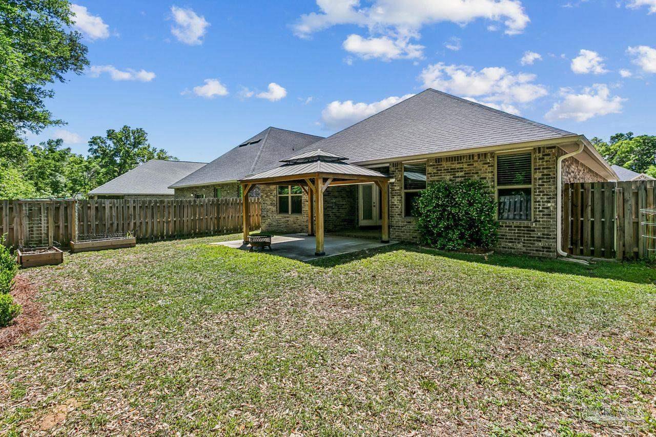 3875 Shady Grove Drive Pace, FL 32571 - Photo 29 of 31 a view of a house with a yard