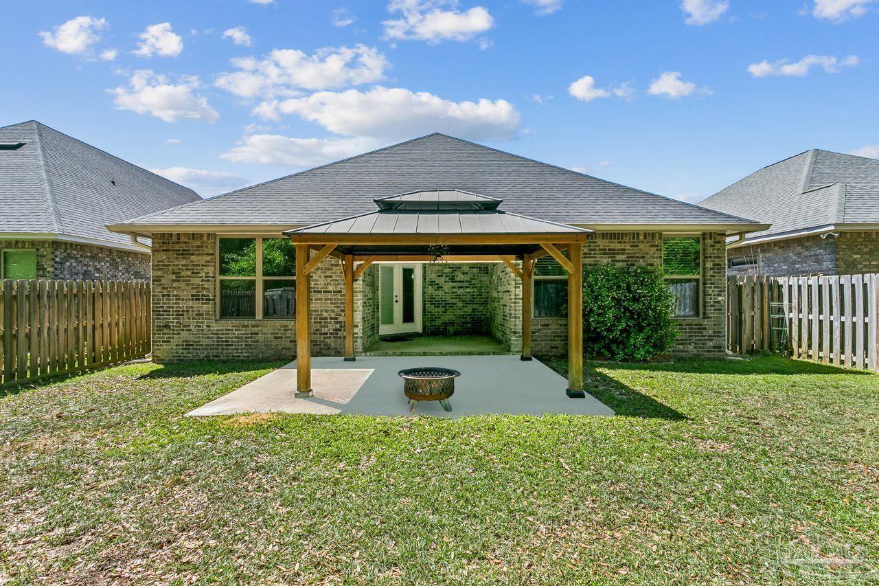 3875 Shady Grove Drive Pace, FL 32571 - Photo 30 of 31 a swimming pool with outdoor seating and yard