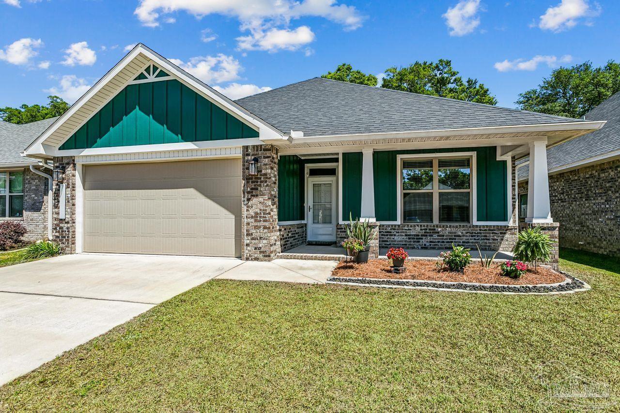3875 Shady Grove Drive Pace, FL 32571 - Photo 3 of 31 a front view of a house with swing and slide