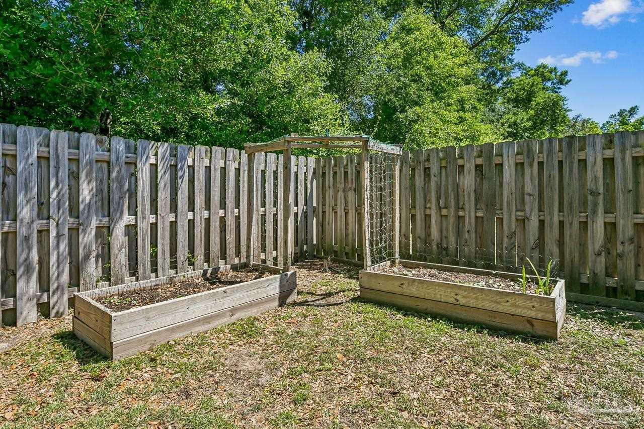 3875 Shady Grove Drive Pace, FL 32571 - Photo 31 of 31 a view of a bench in a backyard