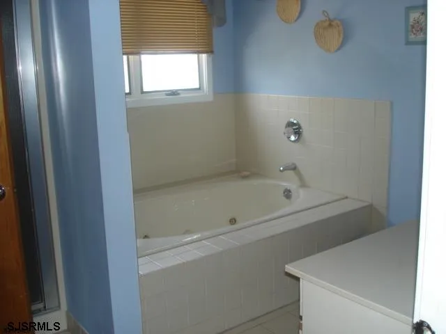 a bathroom with a bathtub and shower