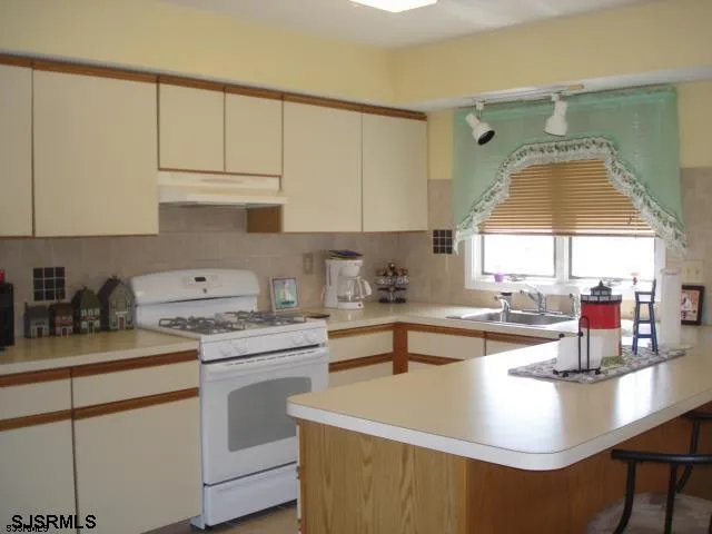 a kitchen with a sink cabinets and window