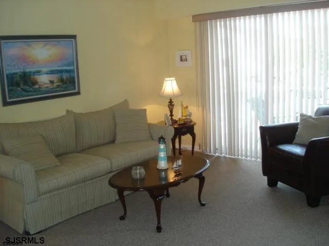 a living room with furniture and a lamp