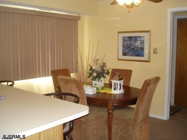 a view of a dining room with furniture and a chandelier
