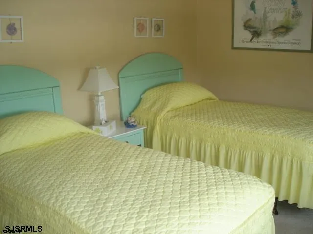 a bed sitting in a bedroom next to a yellow wall