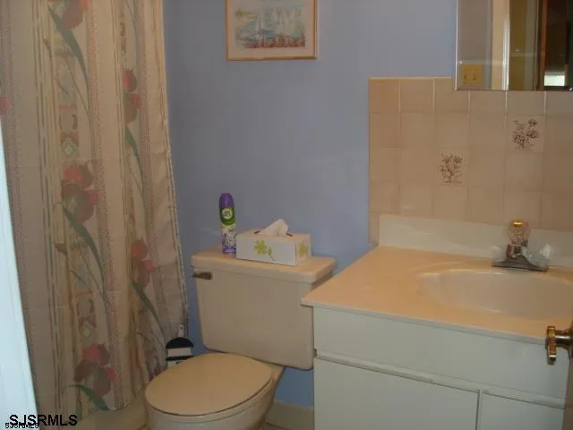 a bathroom with a sink a toilet and a tub