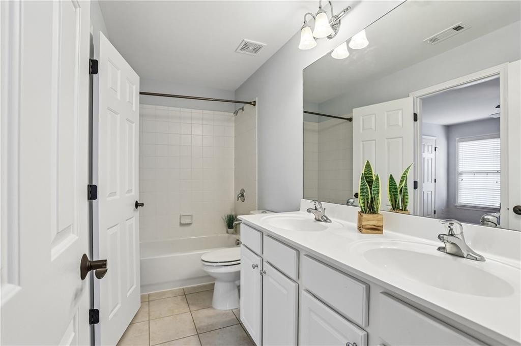 810 Freedom Way Cumming, GA 30040 - Photo 33 of 61 a bathroom with a double vanity sink mirror double and toilet