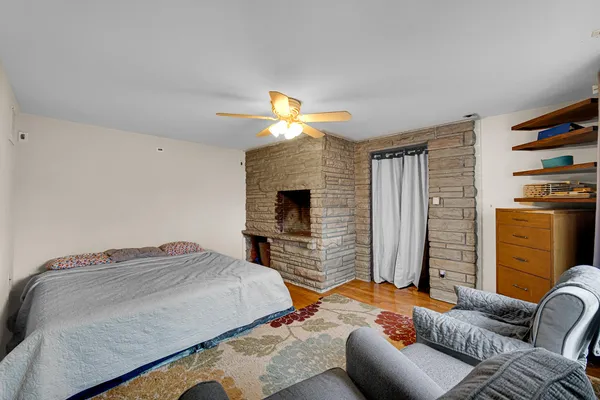 a bedroom with bed and a fireplace