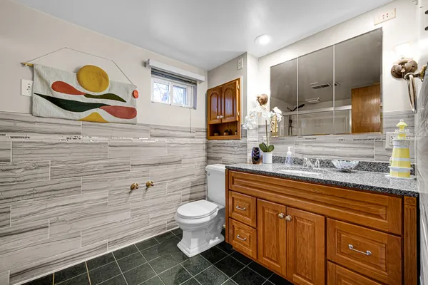 a bathroom with a toilet sink and mirror
