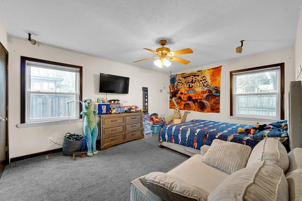 a bedroom with furniture and a flat screen tv
