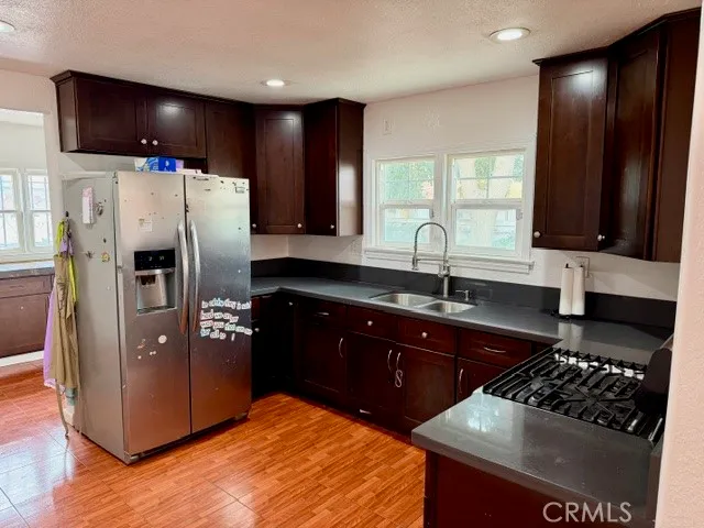 a kitchen with stainless steel appliances granite countertop a refrigerator stove and sink