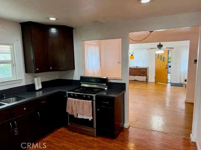 a kitchen with granite countertop a stove and cabinets