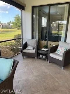 a living room with furniture and a floor to ceiling window