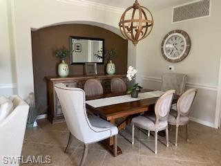 3149 Aviamar Circle, Unit 101 Naples, FL 34114 - Photo 7 of 20 a dining room with a wooden table and a clock