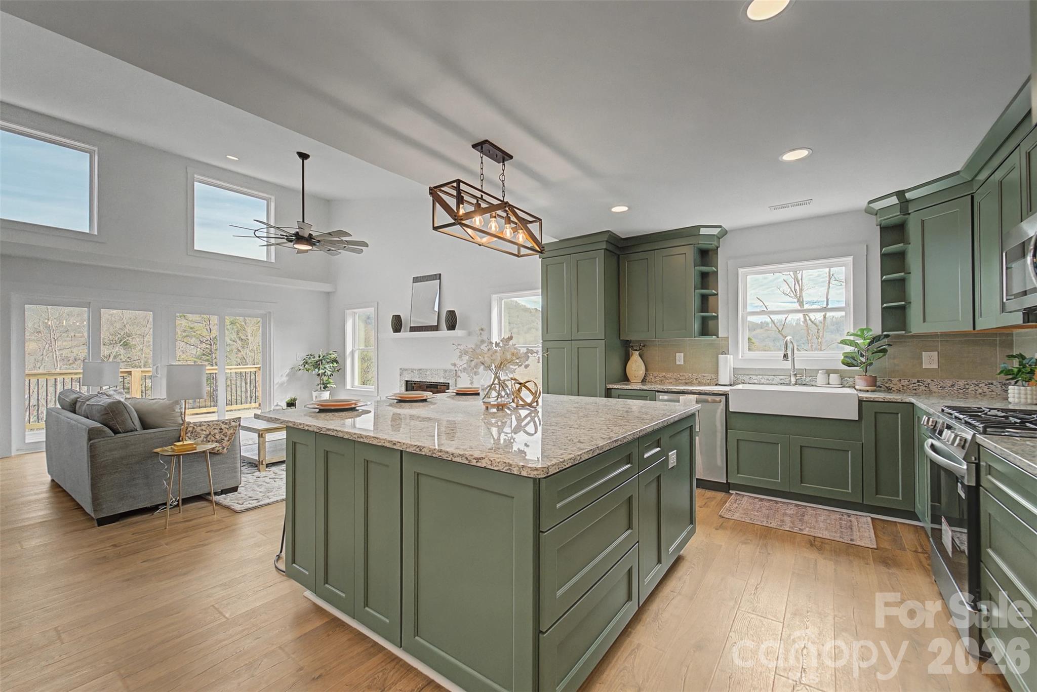 1012 Sols Creek Church Road Tuckasegee, NC 28783 - Photo 11 of 25 a kitchen with kitchen island granite countertop a sink stove and cabinets