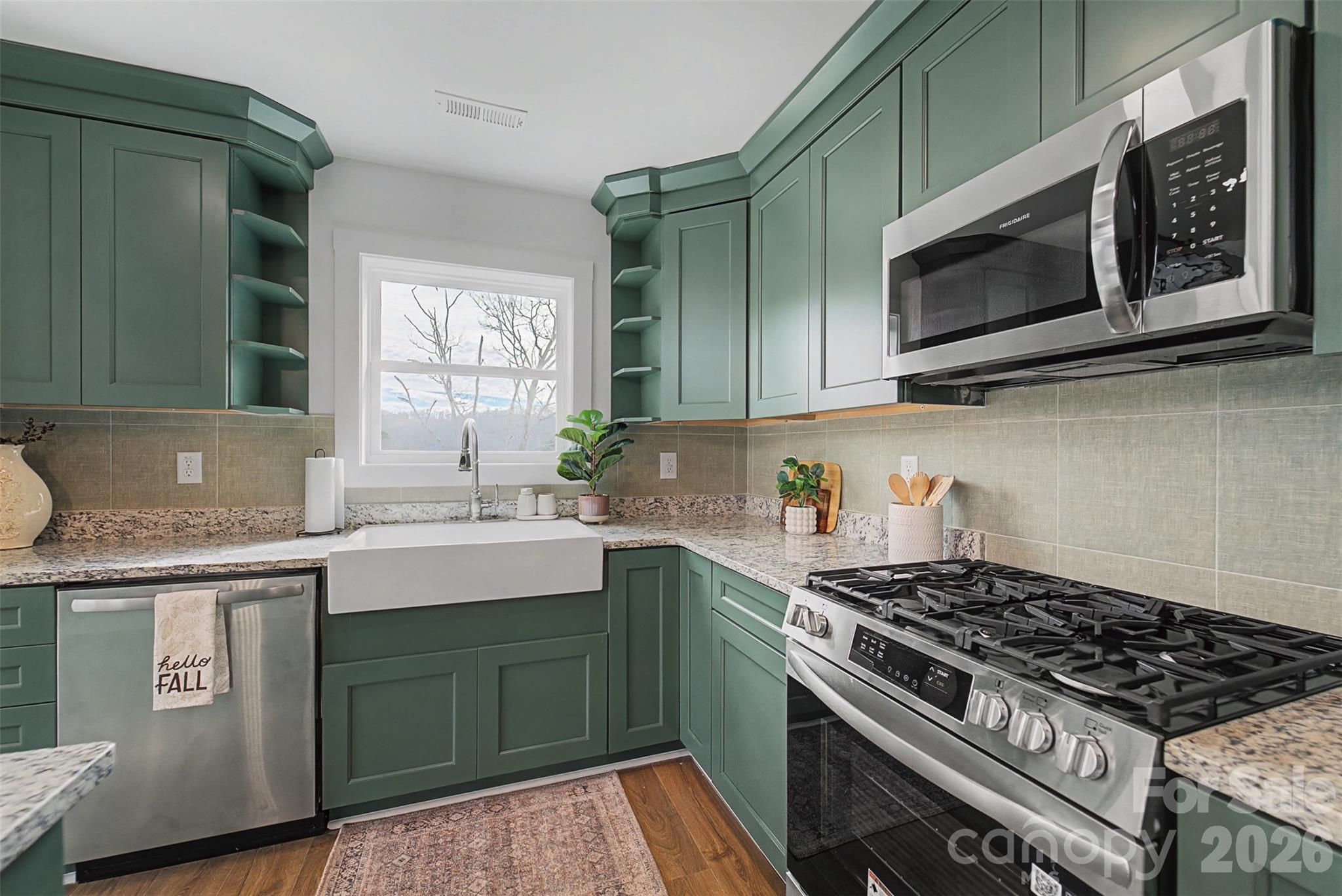 1012 Sols Creek Church Road Tuckasegee, NC 28783 - Photo 12 of 25 a kitchen with stainless steel appliances a stove a sink and a microwave
