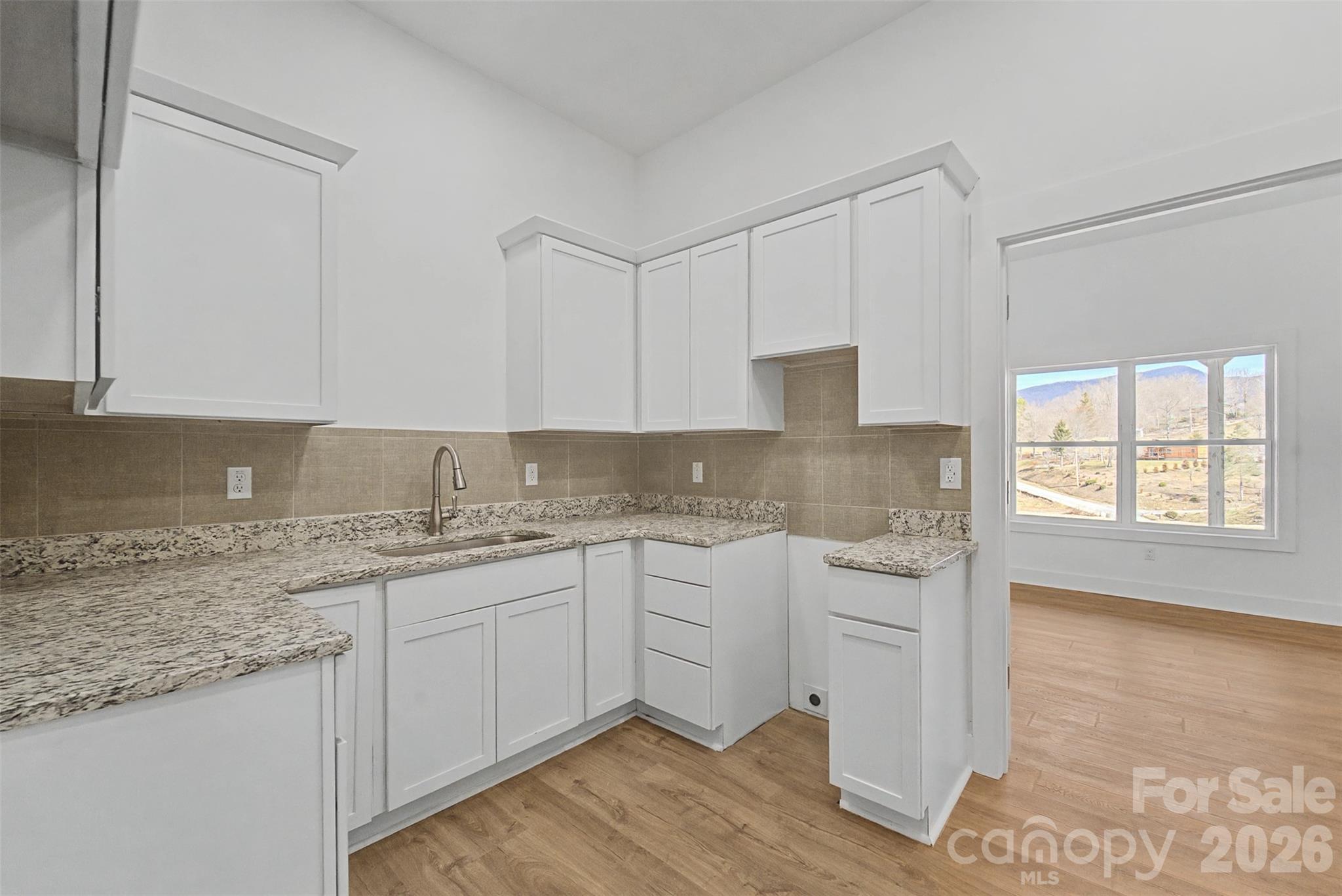 1012 Sols Creek Church Road Tuckasegee, NC 28783 - Photo 18 of 25 a kitchen with a sink cabinets and window
