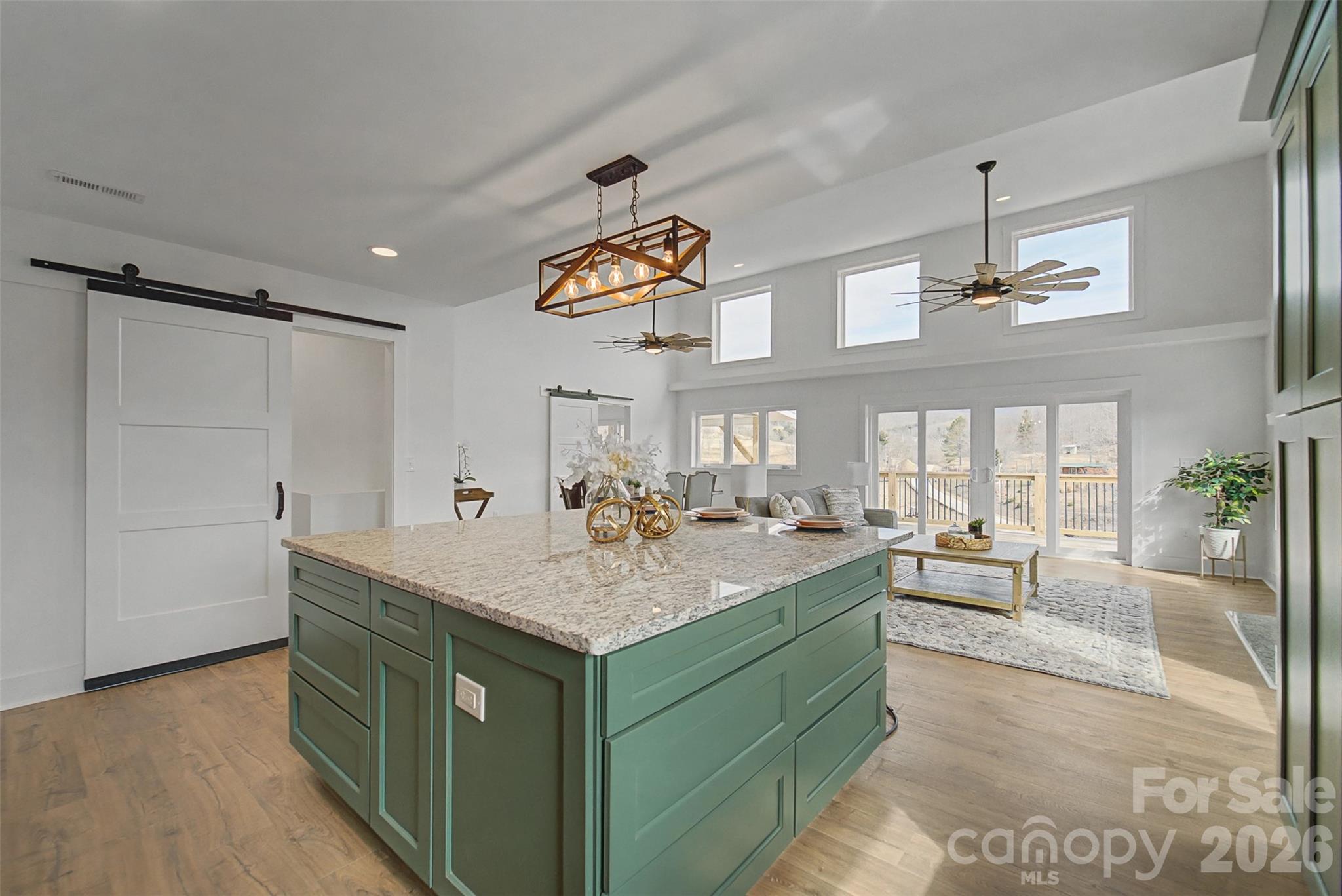 1012 Sols Creek Church Road Tuckasegee, NC 28783 - Photo 4 of 25 a kitchen with a stove a counter top space and a chandelier