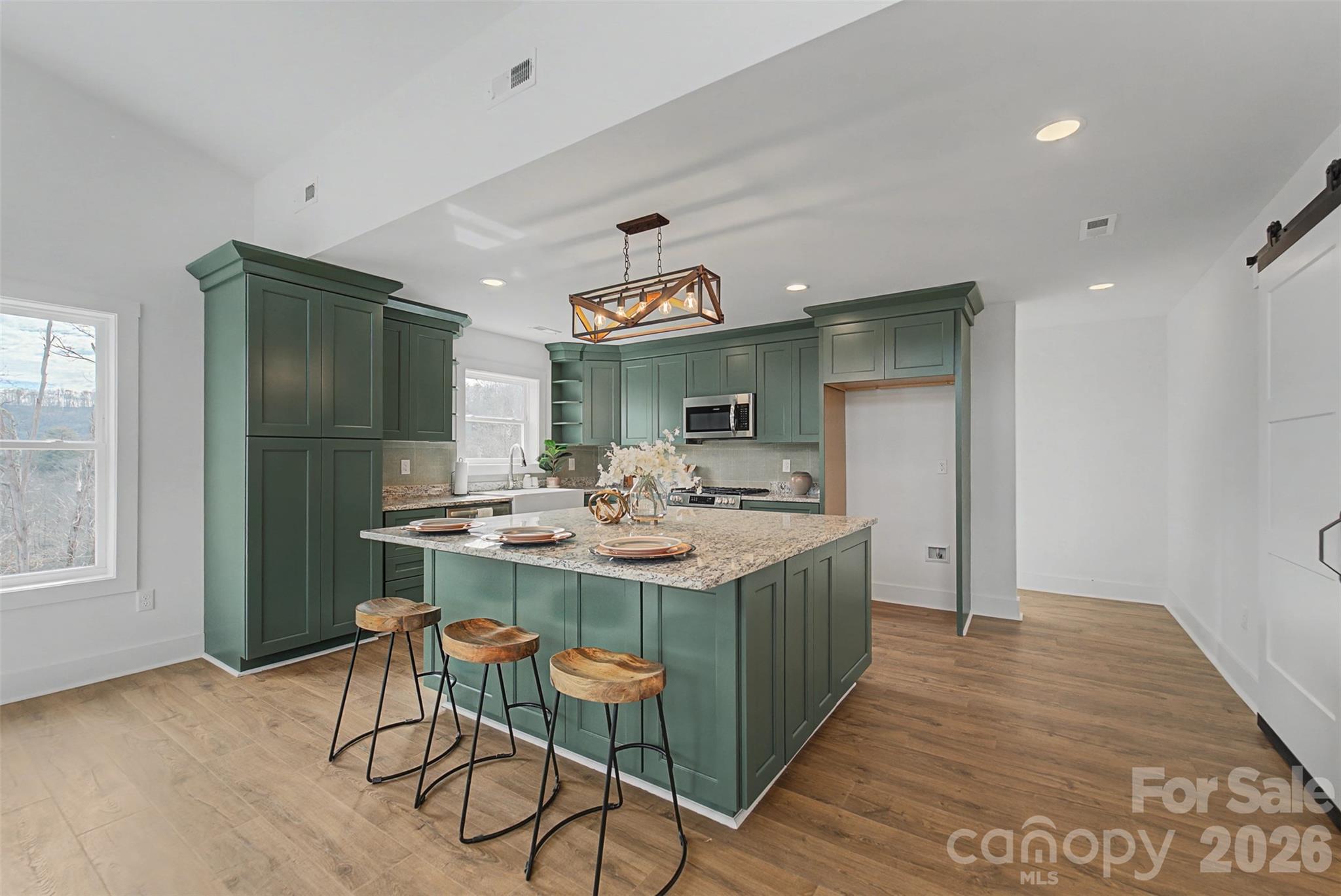 1012 Sols Creek Church Road Tuckasegee, NC 28783 - Photo 8 of 25 a kitchen with kitchen island a sink and a stove
