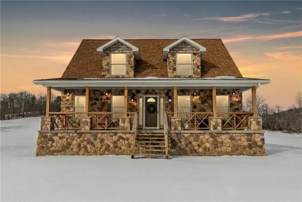 a living room with a couch and chandelier