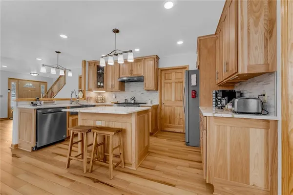 a kitchen with a sink appliances and cabinets