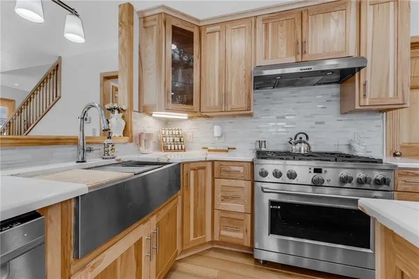 a kitchen with stainless steel appliances granite countertop a stove and a sink