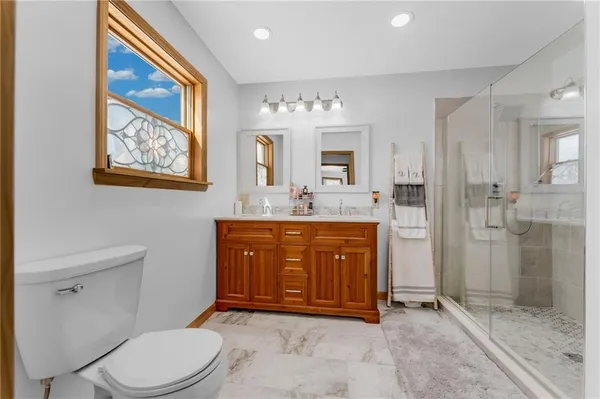 a bathroom with a shower sink and mirror