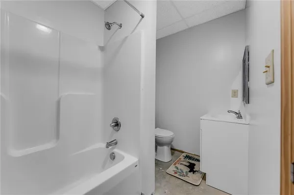 a bedroom with furniture and a rug