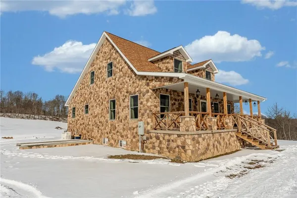 a view of a house with a snow in the yard