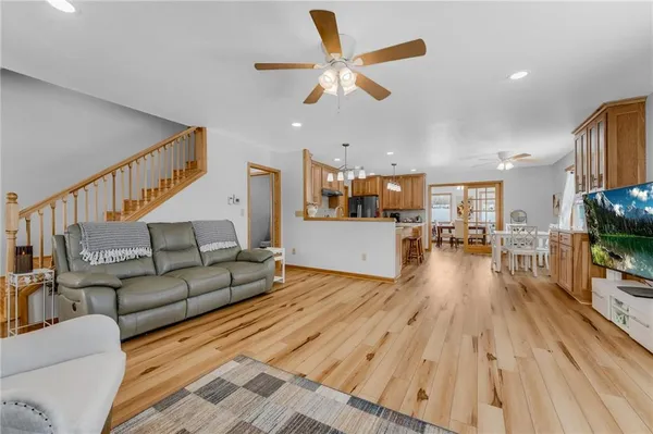 a living room with furniture and kitchen view