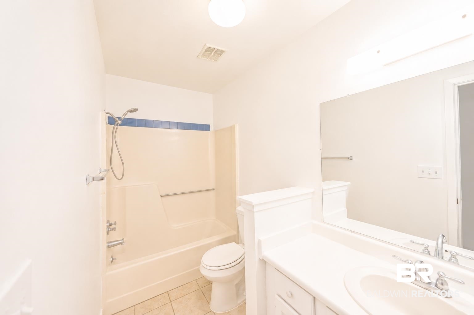 614 East Gate Circle Foley, AL 36535 - Photo 24 of 31 Bathroom featuring a combination shower and tub with grab bar, blue accent tile, tile flooring, and a single vanity with an integrated sink and large wall mirror