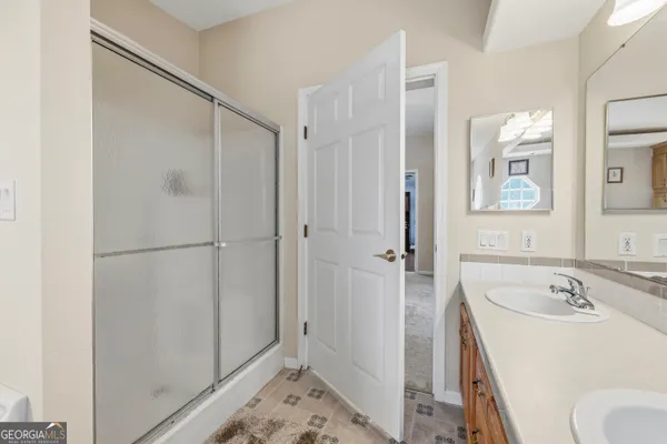 a bedroom with a bed a mirror and a window