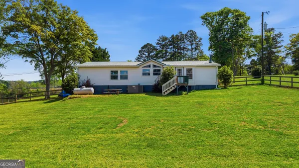 a front view of a house with yard and green space