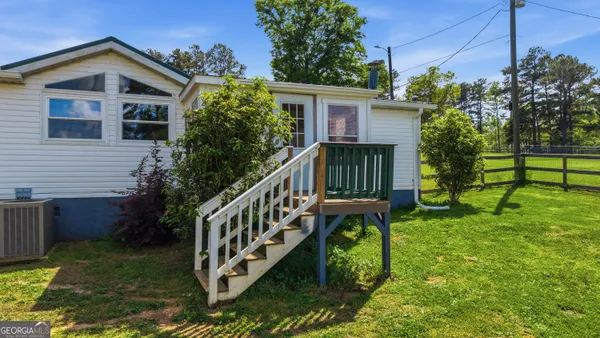 a deck with wooden floor and lake view