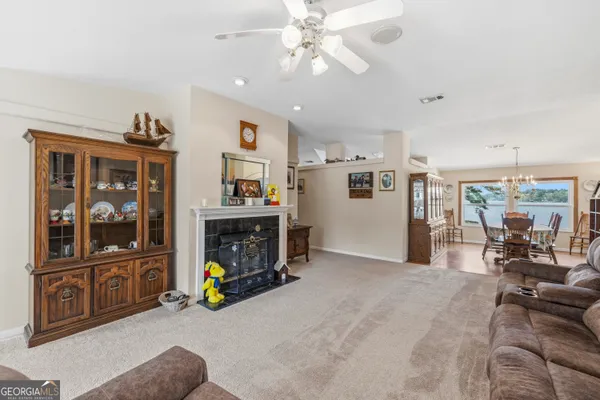 a view of a livingroom with furniture hardwood floor and workspace