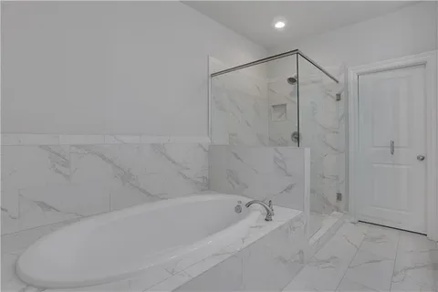a view of a double sink shower and a tub