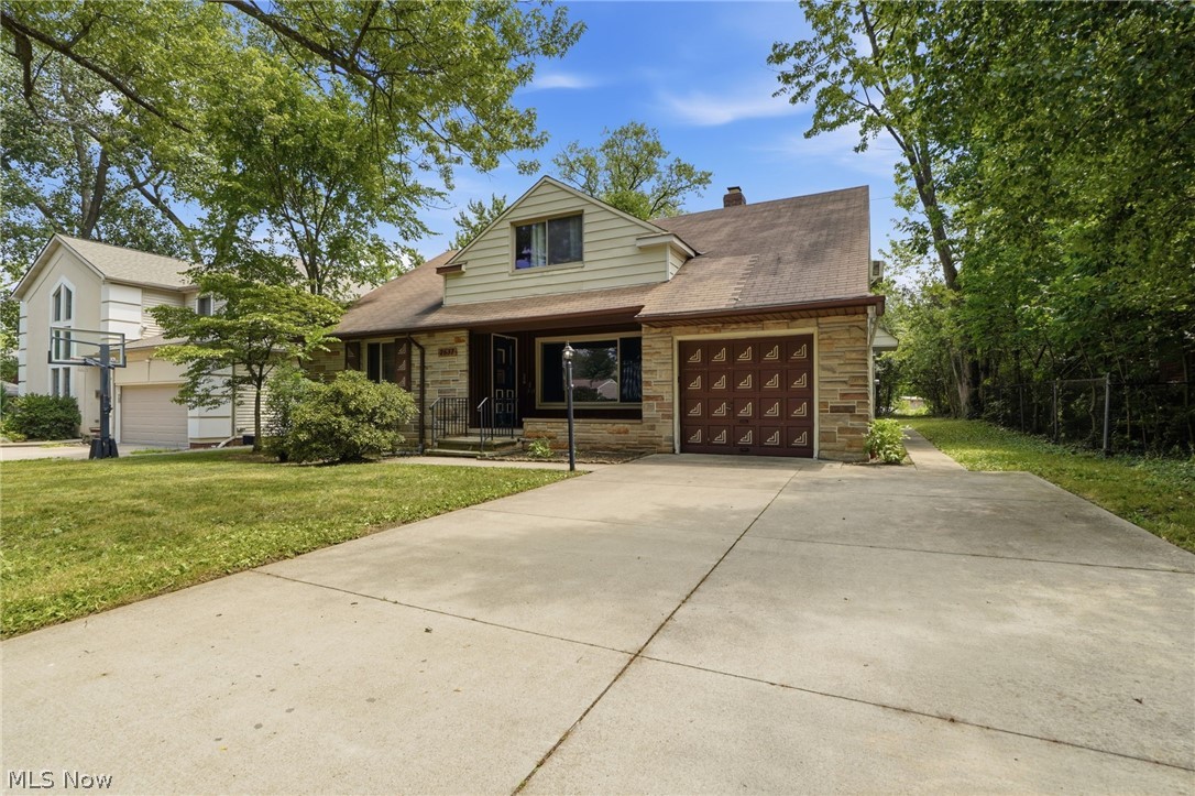 2537 Edgewood Road Beachwood, OH 44122 - Photo 4 of 39 Concrete driveway leading to a stone-front residence with a brown garage door