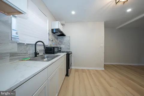 a view of room with window and wooden floor