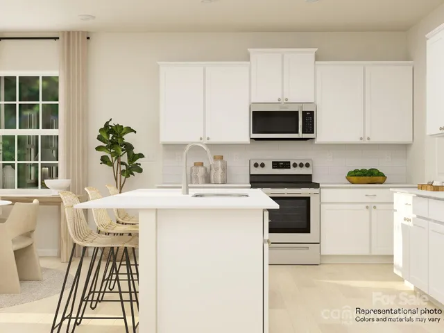 a kitchen with a sink stove and white cabinets