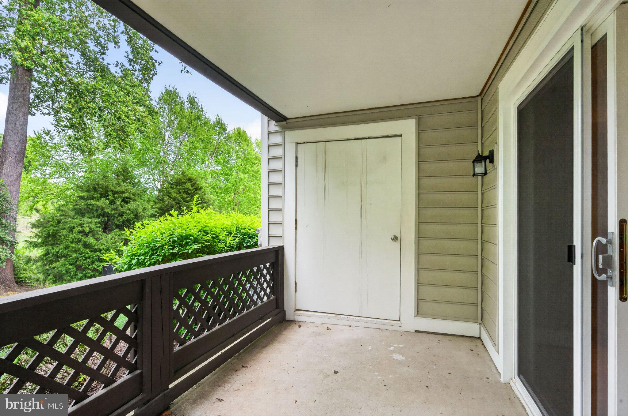 10146 Oakton Terrace Road, Unit 10146 Oakton, VA 22124 - Photo 23 of 25 Serene porch with lush greenery view.