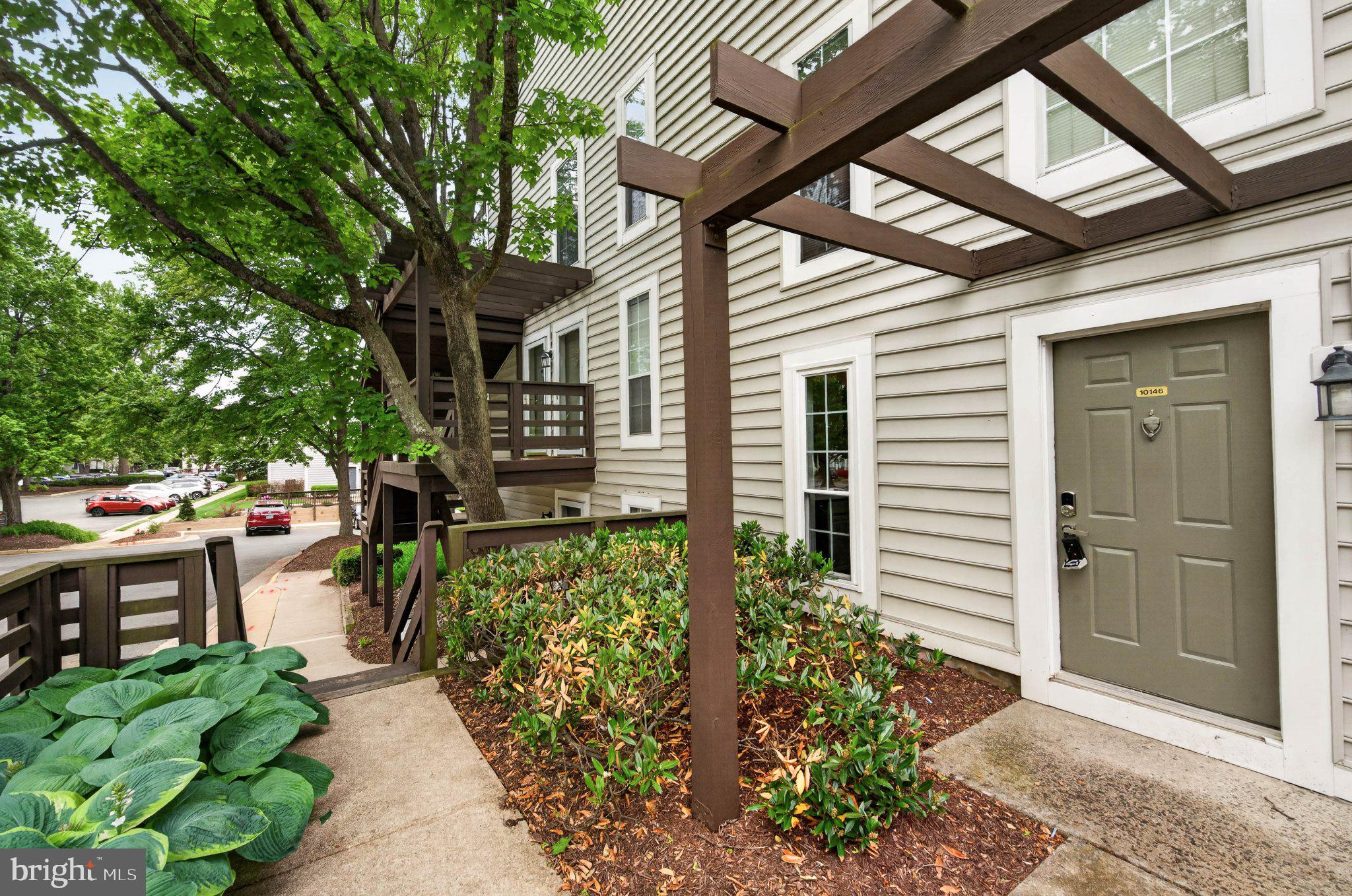 10146 Oakton Terrace Road, Unit 10146 Oakton, VA 22124 - Photo 4 of 25 Charming entrance with lush greenery.