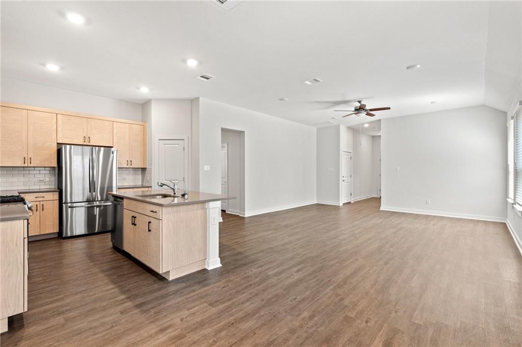 1012 Paddock Lane Georgetown, TX 78626 - Photo 4 of 15 An open-concept living space with a contemporary kitchen offers seamless entertaining.