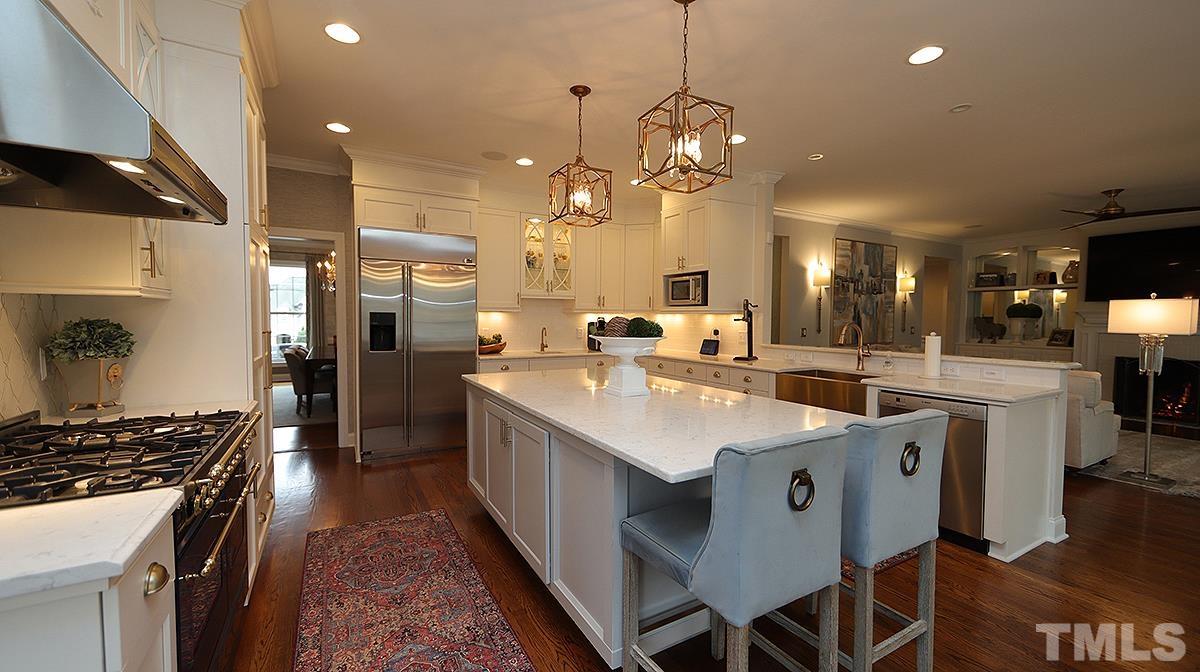 414 Yarmouth Road Raleigh, NC 27608 - Photo 15 of 42 a large kitchen with a table and chairs