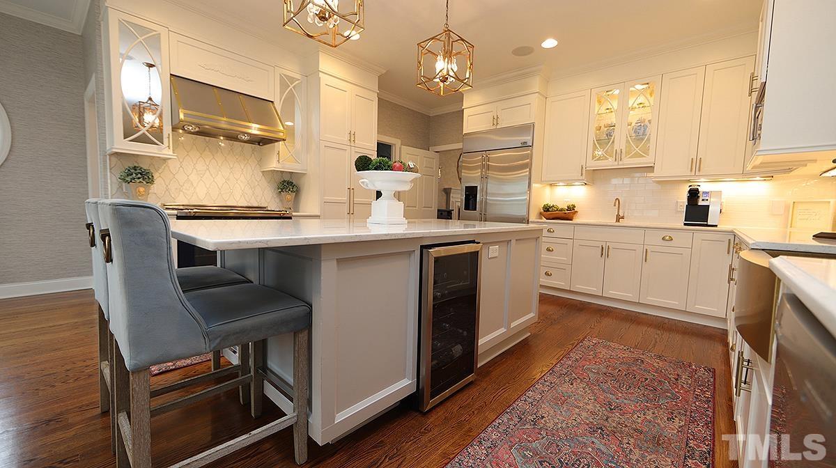 414 Yarmouth Road Raleigh, NC 27608 - Photo 16 of 42 a kitchen with cabinets a sink dishwasher a stove and a refrigerator